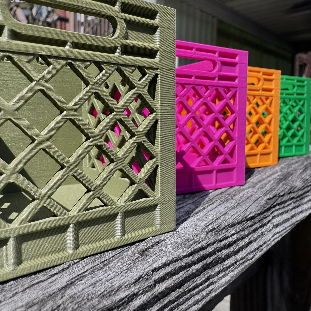Olive, pink, orange, and green 3D-printed collaboration crates
